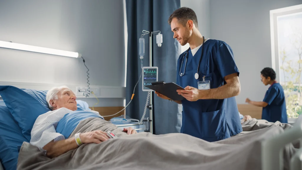 Médico realiza monitoramento de sinais vitais em paciente hospitalizado para cirurgia de coluna em idosos.
